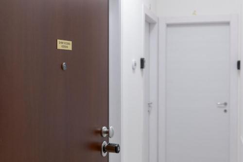 a door with a sign on it next to two doors at Shiny Rooms Verona in Verona