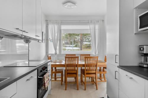 a kitchen and dining room with a table and chairs at Happy house in Helsinki