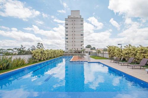 a swimming pool with a building in the background at Studio Business Alto da Boa Vista - Perto do Consulado e Transamérica in Sao Paulo