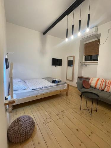 a bedroom with a bed and a couch in a room at Sebastian`s stylish apartment in old town in Tbilisi City