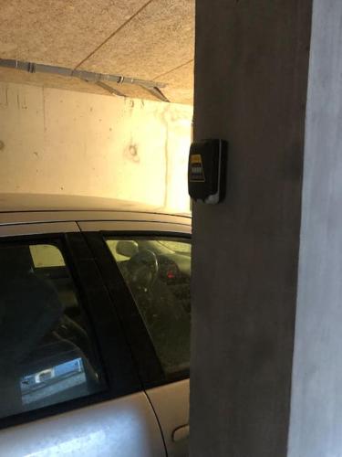a car parked in a garage next to a building at Appartement avec deux chambres. in Argelès-Gazost