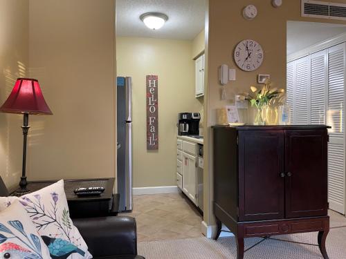 a living room with a couch and a clock on the wall at Gatlinburg Summit Getaway for 2 With Amazing View! in Gatlinburg