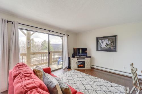 a living room with a couch and a large window at Beech Mountain Studio with Balcony Less Than 1 Mi to Skiing! in Beech Mountain