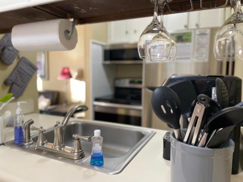 a kitchen sink with a utensil holder next to it at Gatlinburg Summit Getaway for 2 With Amazing View! in Gatlinburg