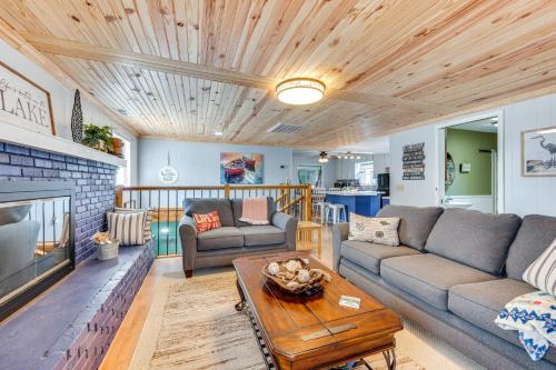 a living room with a couch and a table at Lakefront New London Home Dock, Fire Pit and Views! in New London