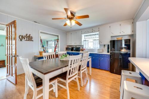 a kitchen with a dining table and a ceiling fan at Lakefront New London Home Dock, Fire Pit and Views! in New London