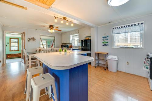 a kitchen with a blue island in the middle at Lakefront New London Home Dock, Fire Pit and Views! in New London