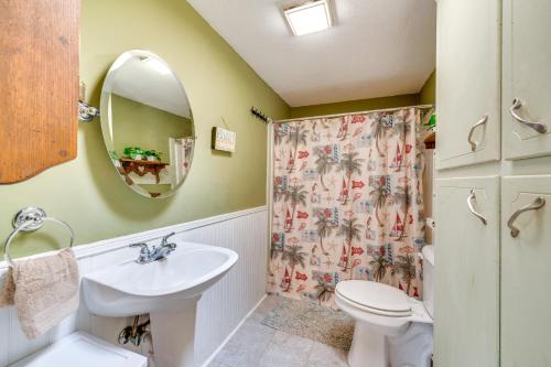 a bathroom with a sink and a toilet and a mirror at Lakefront New London Home Dock, Fire Pit and Views! in New London