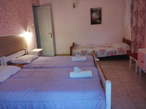 a bedroom with two beds with towels on them at Vanilla House Paleokastritsa in Paleokastritsa