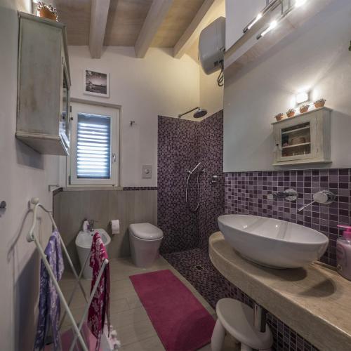 a bathroom with a sink and a toilet at Chalet Tango in Contrada Sauci Grande