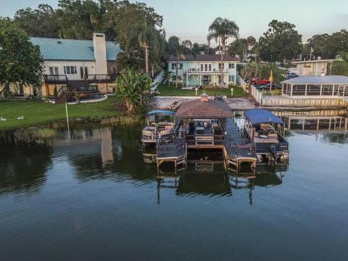 a group of boats parked at a dock in the water at Lakefront Duplex with Pontoon Boat 2 Bedroom Home in Mount Dora