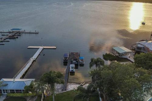 an aerial view of a body of water with a dock at Lakefront Duplex with Pontoon Boat 2 Bedroom Home in Mount Dora