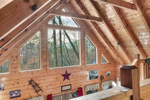 a room with wooden walls and windows in a cabin at Private! Hot Tub, Views, & Games in Sevierville