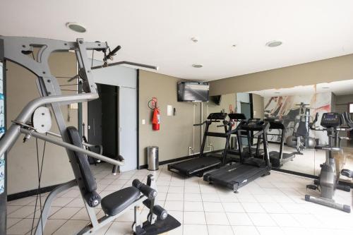 a gym with several treadmills and elliptical machines at Flat Metropoles Ilha do Leite by Easy Home in Recife