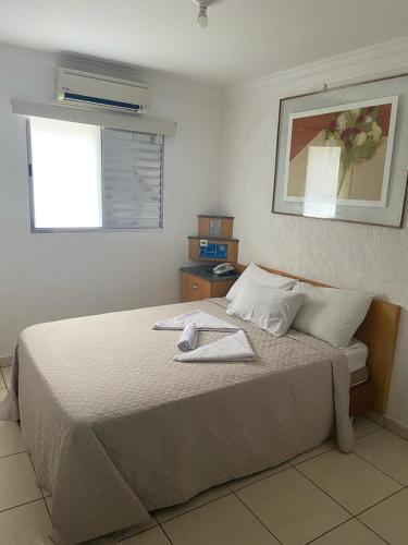 a bedroom with a bed with a towel on it at Hotel Mooca in Sao Paulo