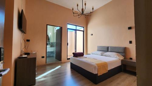 a bedroom with a bed and a television in it at Casa Madero 227 in Aguascalientes