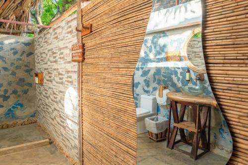 a bathroom with a sink and a toilet in a room at La Playita Isla Fuerte in Isla Fuerte