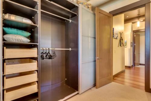 a walk in closet with a glass door at Stunning Coeur dAlene Condo Walk Downtown in Coeur d'Alene