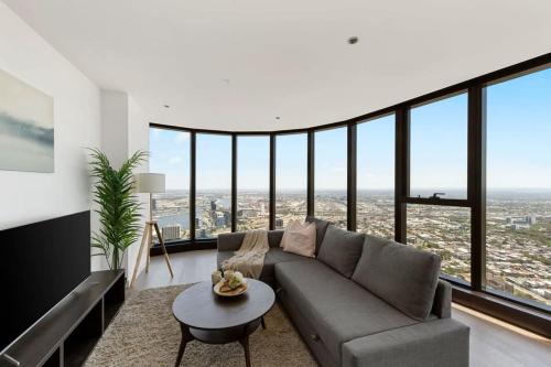 a living room with a couch and a table at A Cozy 3BR Apt with Panoramic Views FREE Parking in Melbourne