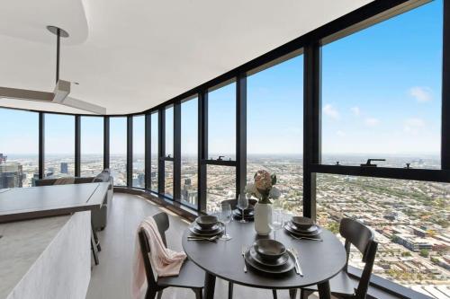 a dining room with a table and views of the city at A Cozy 3BR Apt with Panoramic Views FREE Parking in Melbourne