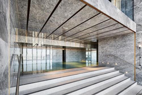 a staircase in a building with a swimming pool at A Cozy 3BR Apt with Panoramic Views FREE Parking in Melbourne