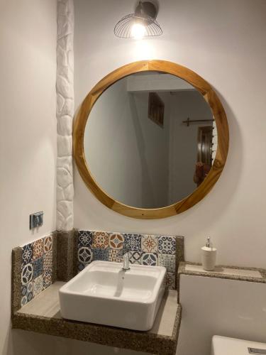 a bathroom with a white sink and a mirror at Hotel La Costa International Salango in Puerto López