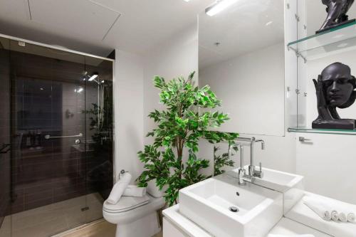 a bathroom with a sink and a toilet and a shower at A Cozy Apt Near Grand Prix Circuit FREE Parking in Melbourne