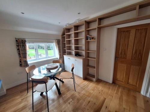 a dining room with a table and chairs in a room at Rural Retreat near Dorking in Dorking