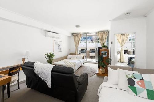 a living room with a couch and a table at A Stylish Apt for 6 Right Next to Darling Harbour in Sydney