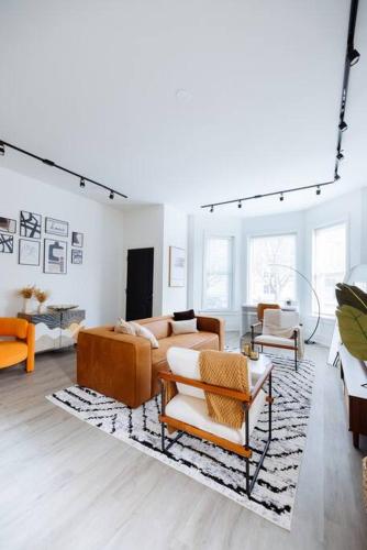 a living room with a lot of furniture in it at The Brown House - A luxurious UChicago Campus stay in Chicago