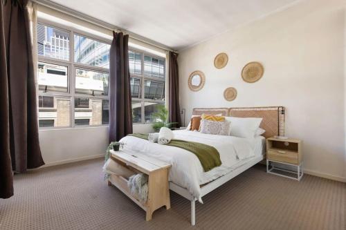 a bedroom with a large bed and a large window at A Plush & Comfy Apt Right Next to Darling Harbour in Sydney