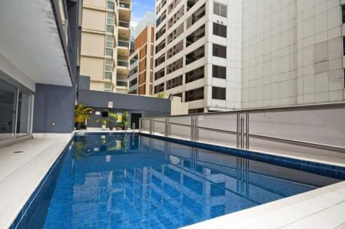 a large swimming pool in the middle of a building at A Plush & Comfy Apt Right Next to Darling Harbour in Sydney