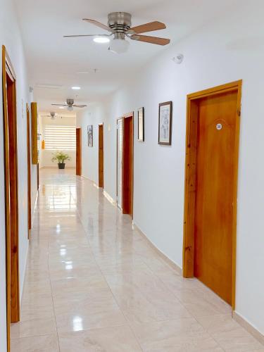 a hallway with white walls and a ceiling at Hotel Grand Caribe in San Andrés