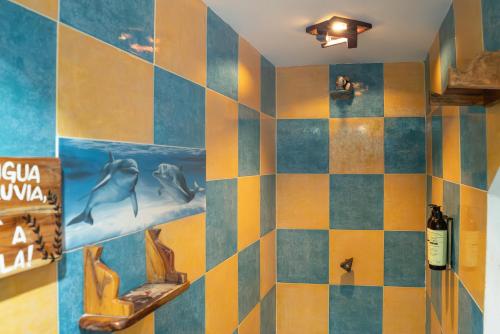a bathroom with a colorful tiled wall with fish on it at La Playita Isla Fuerte in Isla Fuerte