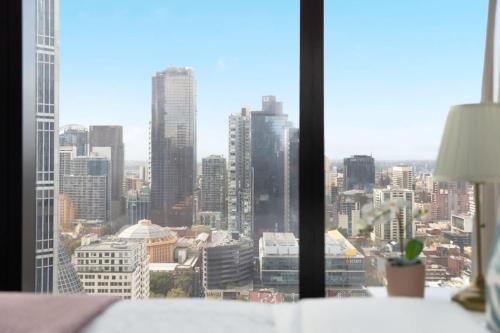 a view of a city skyline from a window at A Chic 2BR Apt Near Melbourne CBD w FREE Parking in Melbourne