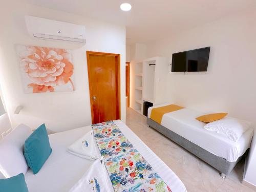 a hotel room with a bed and a tv at Hotel Grand Caribe in San Andrés