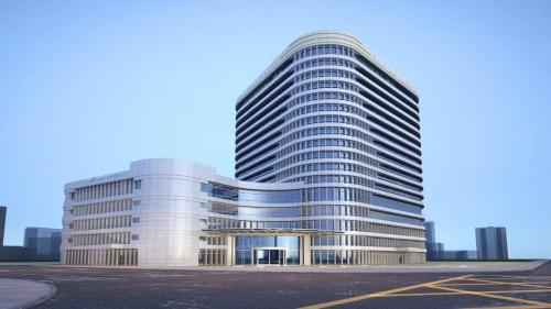 a tall office building with a lot of windows at EVEN Hotel Yinchuan Yuehai by IHG in Yinchuan