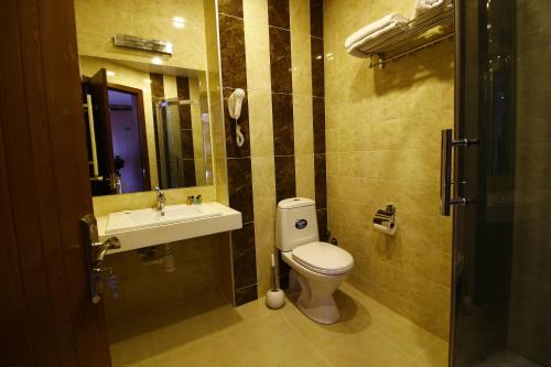a bathroom with a toilet and a sink at Sani Hotel in Tbilisi City