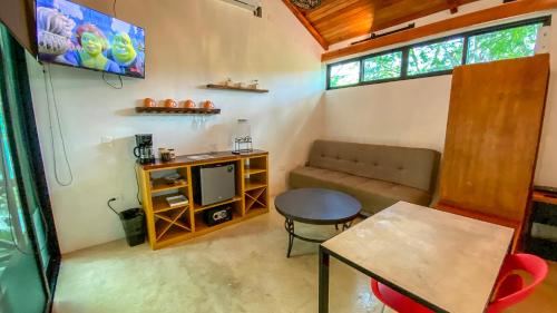 a living room with a couch and a table at Villas Zamna - Jungle Villas in Cozumel