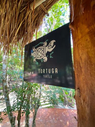 a sign on a tree with a picture of a zebra at Villas Zamna - Jungle Villas in Cozumel