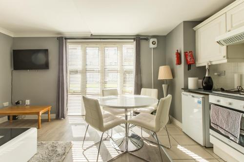 a kitchen and dining room with a table and chairs at Modern Elegant Central Apt with Parking in Dublin