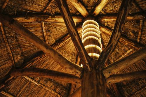 an elephant in the ceiling of a straw roof at Villas Zamna - Jungle Villas in Cozumel