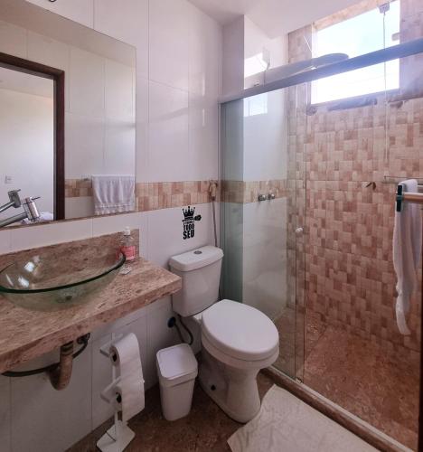 a bathroom with a toilet and a sink and a shower at Pousada MarÍsis Barra da Tijuca in Rio de Janeiro