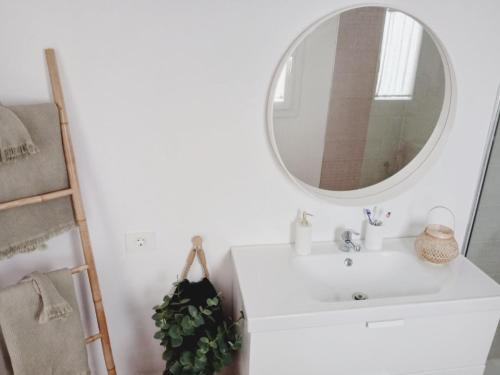 a bathroom with a white sink and a mirror at Apartamento Casa Rosabella in Caleta de Sebo