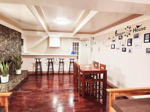 a dining room with a wooden table and chairs at City Oasis: Steps Away from Urban Buzz in Baguio