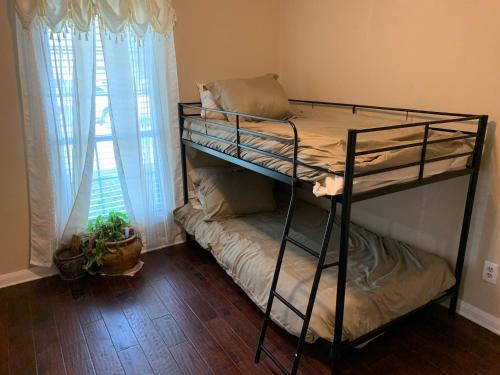 two bunk beds in a room with a window at 290/Cypress/NW Houston/Pets/NewListing in Cypress