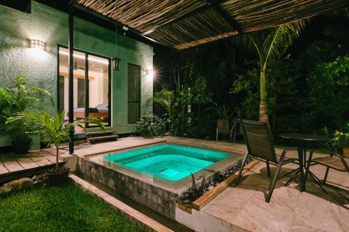a swimming pool in the backyard of a house at Villas Zamna - Jungle Villas in Cozumel
