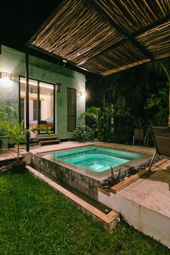 a swimming pool in a backyard at night at Villas Zamna - Jungle Villas in Cozumel