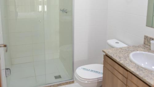 a bathroom with a shower and a toilet and a sink at Flat2 Saint Moritz in Brasilia