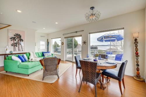 a living room with a green couch and a table at Beautiful Birch Bay Retreat with Deck and Fire Pit! in Blaine